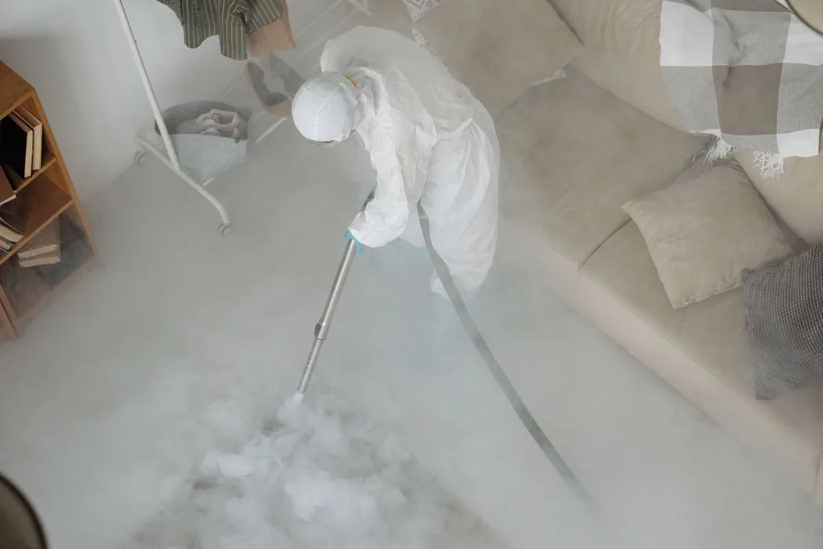 Biohazard cleanup technician in protective equipment, Coker, AL